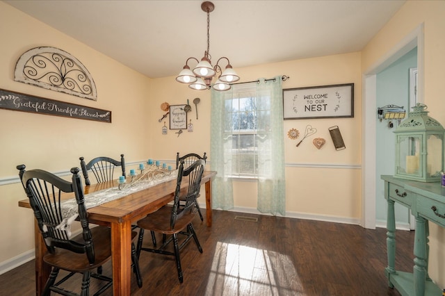 dining area with an inviting chandelier and dark hardwood / wood-style flooring