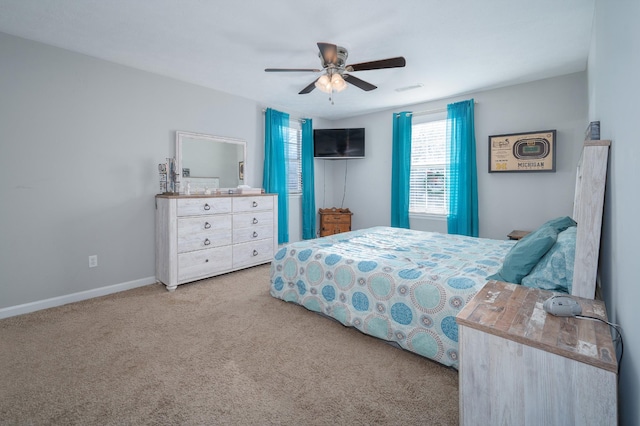 bedroom with ceiling fan and light colored carpet