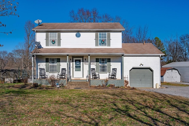 view of front facade with a porch, a front lawn, and a garage