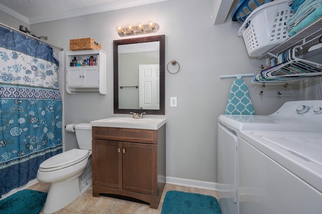 bathroom featuring a textured ceiling, ornamental molding, toilet, washing machine and dryer, and vanity