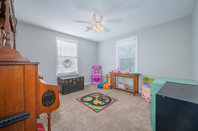 rec room with ceiling fan and carpet