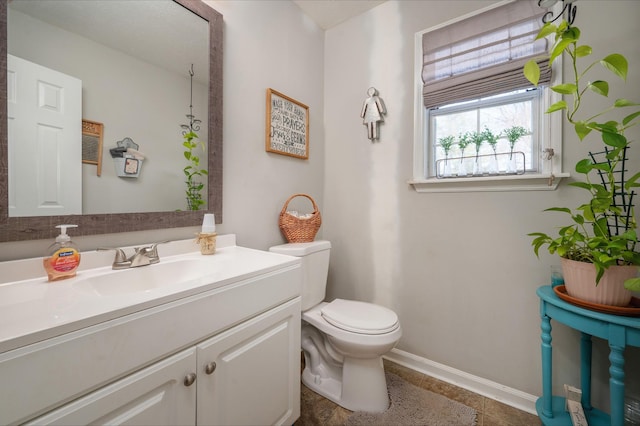 bathroom with toilet, tile patterned flooring, and vanity