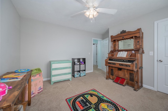 game room with ceiling fan and light carpet