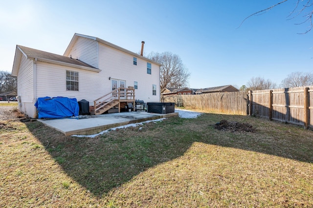 back of house featuring a patio area and a yard