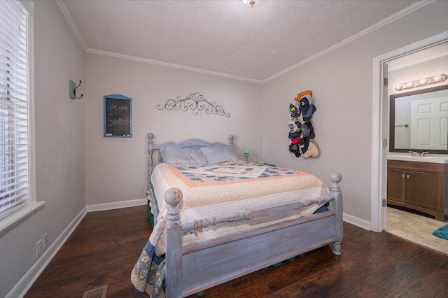 bedroom with sink, dark wood-type flooring, ensuite bathroom, and crown molding