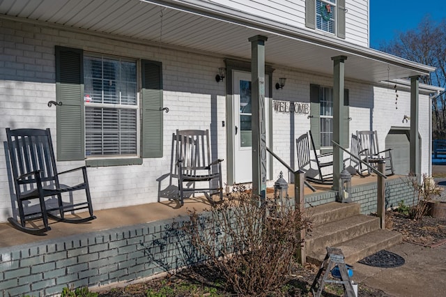 view of exterior entry with covered porch