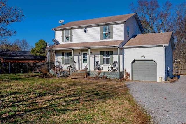 view of front of property featuring covered porch, a front yard, and a garage