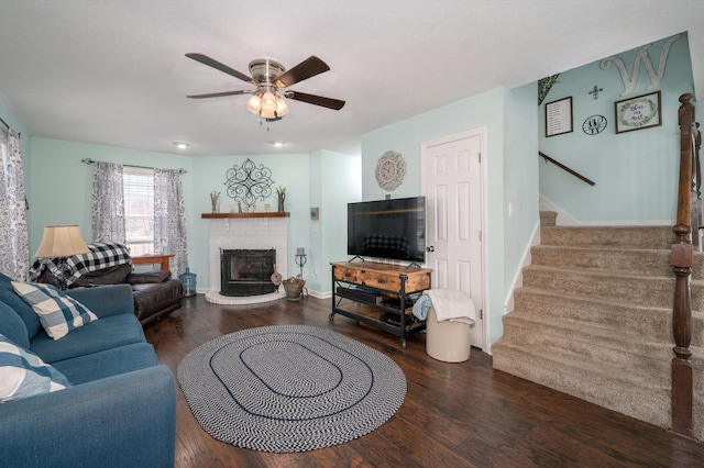 living room with ceiling fan and dark hardwood / wood-style flooring