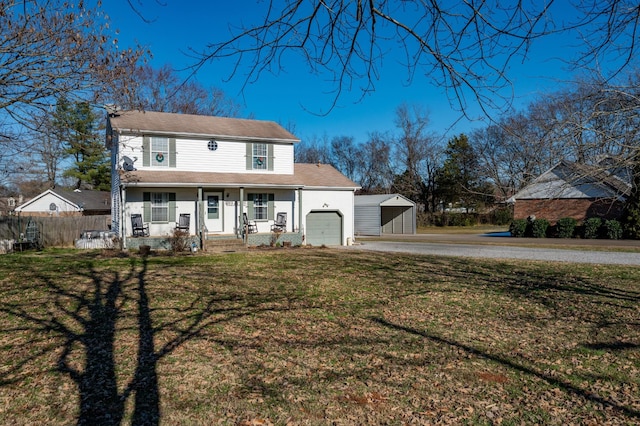 view of front of property with a porch, a front lawn, and a garage