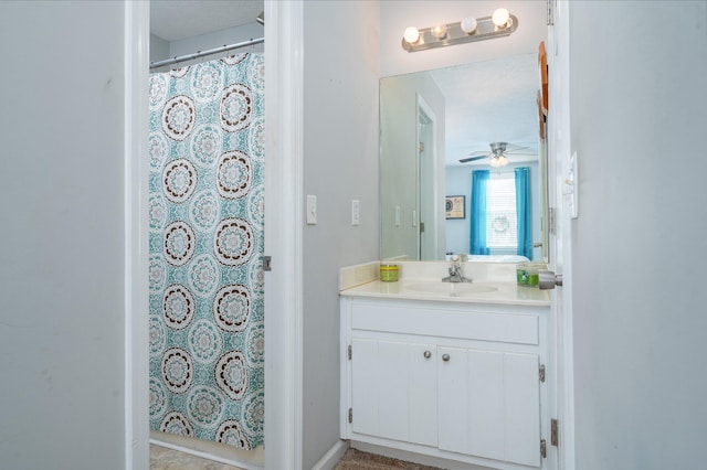 bathroom featuring curtained shower, ceiling fan, and vanity