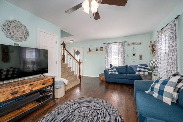 living room featuring ceiling fan and dark hardwood / wood-style floors