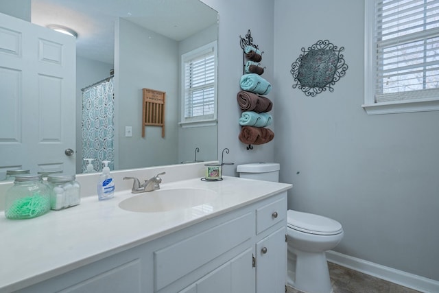 bathroom featuring tile patterned flooring, vanity, and toilet