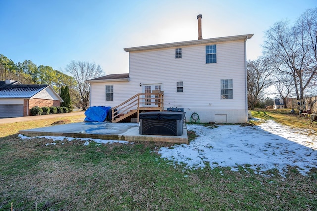 snow covered property with a lawn, a hot tub, and a wooden deck