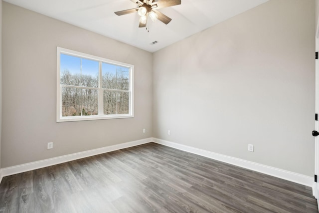 spare room with ceiling fan and dark wood-type flooring