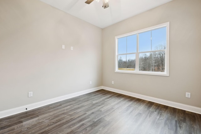 unfurnished room with ceiling fan and dark wood-type flooring