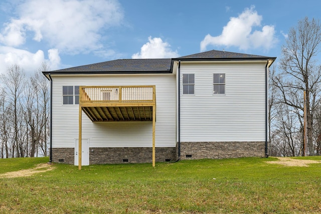 view of side of property featuring a yard and a wooden deck