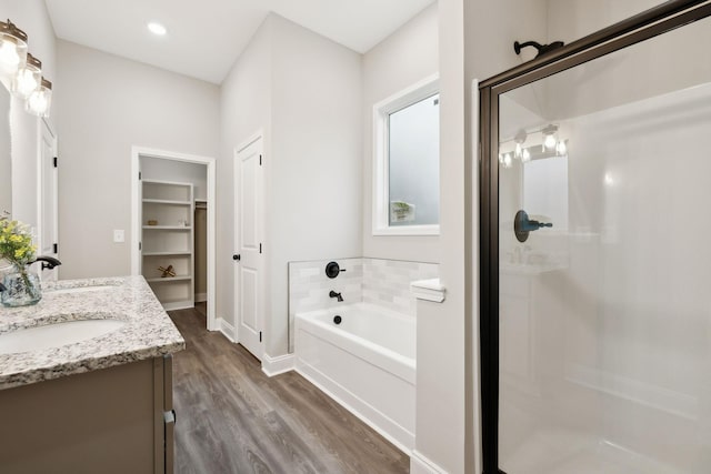 bathroom featuring vanity, hardwood / wood-style flooring, and independent shower and bath