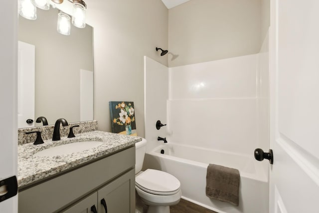 full bathroom featuring hardwood / wood-style floors, vanity, toilet, and tub / shower combination