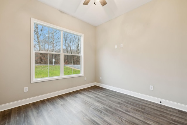 spare room with ceiling fan and dark hardwood / wood-style flooring