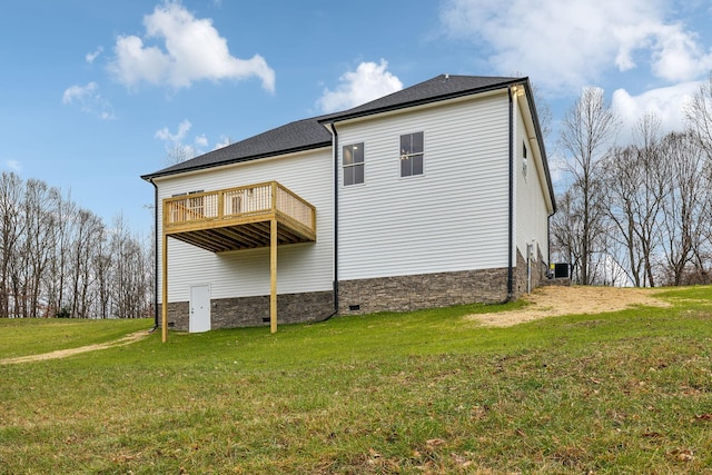 back of property featuring a lawn and a balcony