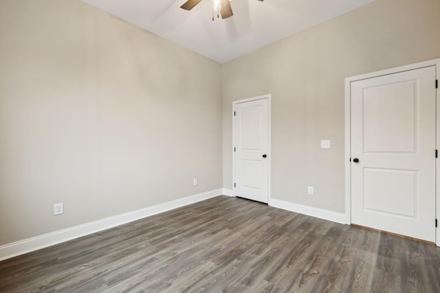 unfurnished bedroom featuring ceiling fan and dark hardwood / wood-style flooring