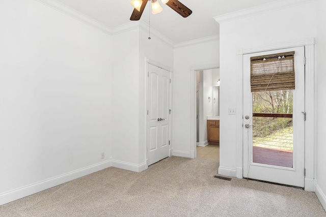 unfurnished room featuring crown molding, ceiling fan, and light colored carpet