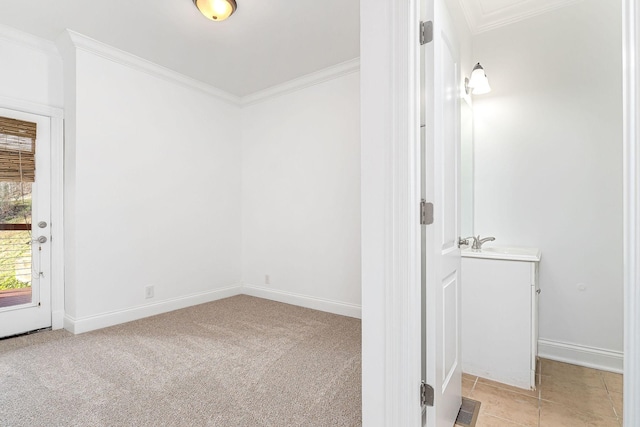 unfurnished room with light colored carpet, ornamental molding, and sink