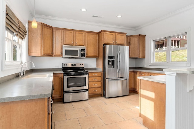 kitchen featuring hanging light fixtures, sink, light tile patterned floors, ornamental molding, and appliances with stainless steel finishes