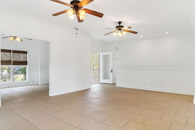 tiled spare room with ceiling fan and crown molding