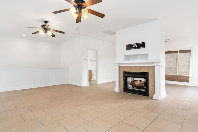 unfurnished living room with a tile fireplace, light tile patterned floors, and ceiling fan