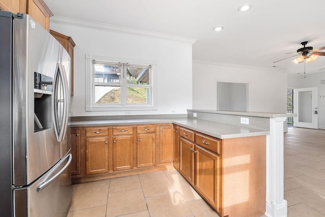 kitchen with kitchen peninsula, a wealth of natural light, light tile patterned flooring, and stainless steel refrigerator with ice dispenser