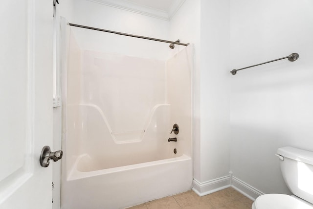 bathroom featuring tile patterned floors, toilet, washtub / shower combination, and crown molding