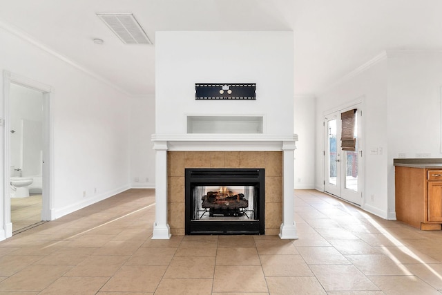 unfurnished living room featuring a fireplace, light tile patterned floors, and crown molding