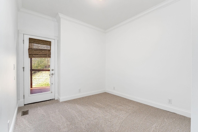 carpeted spare room featuring ornamental molding