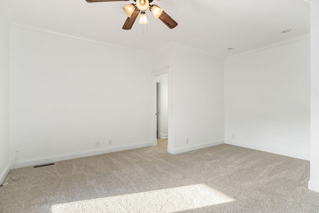 carpeted empty room with ceiling fan and ornamental molding