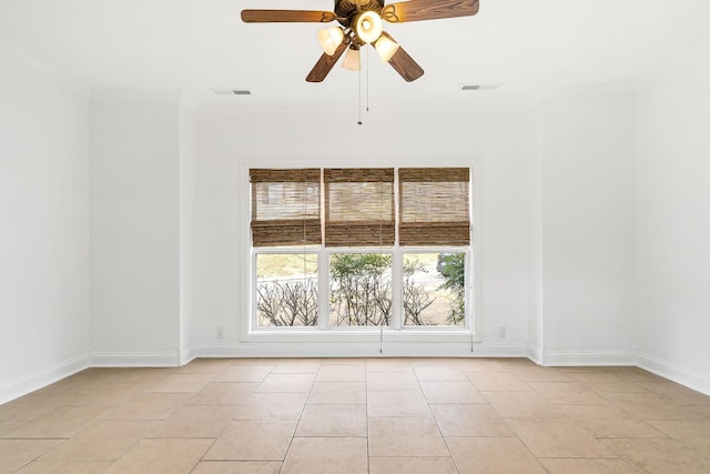 empty room featuring light tile patterned floors, ceiling fan, and crown molding