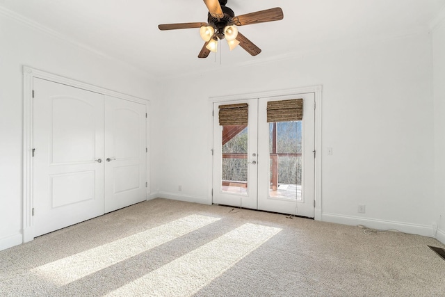 unfurnished bedroom with ceiling fan, french doors, light colored carpet, access to outside, and a closet