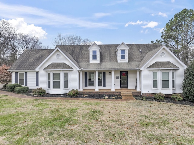 cape cod-style house featuring a porch and a front lawn