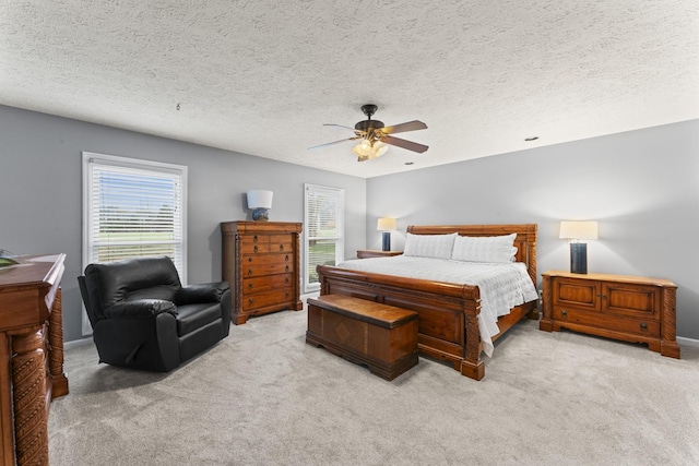 carpeted bedroom featuring a textured ceiling and ceiling fan