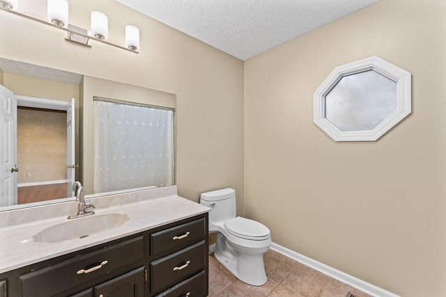 bathroom with tile patterned flooring, vanity, a textured ceiling, a shower with curtain, and toilet