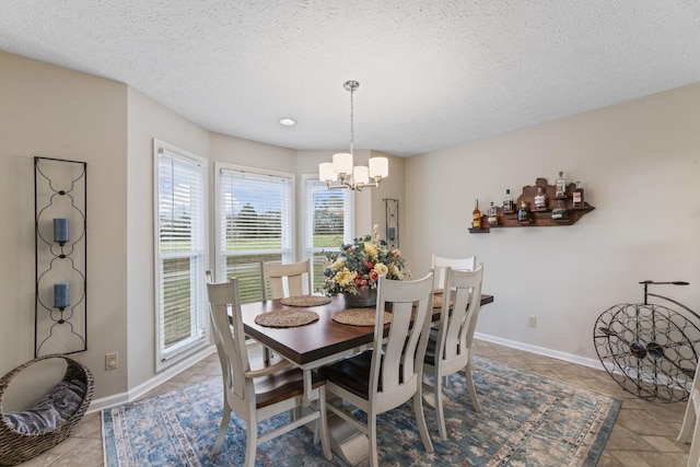 dining room with a notable chandelier and a textured ceiling