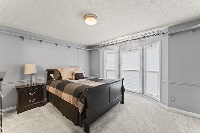 carpeted bedroom with a textured ceiling