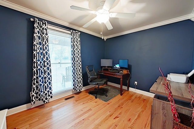 office with hardwood / wood-style flooring, a healthy amount of sunlight, and crown molding