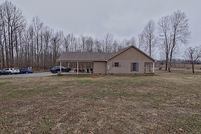 view of front facade featuring a front lawn and a carport