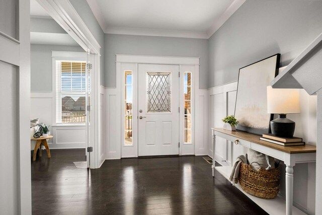 entrance foyer with dark hardwood / wood-style flooring and ornamental molding