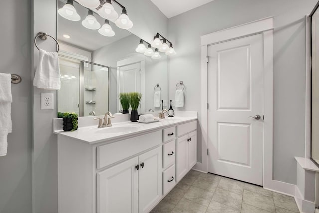 bathroom featuring tile patterned floors, vanity, and a shower with door