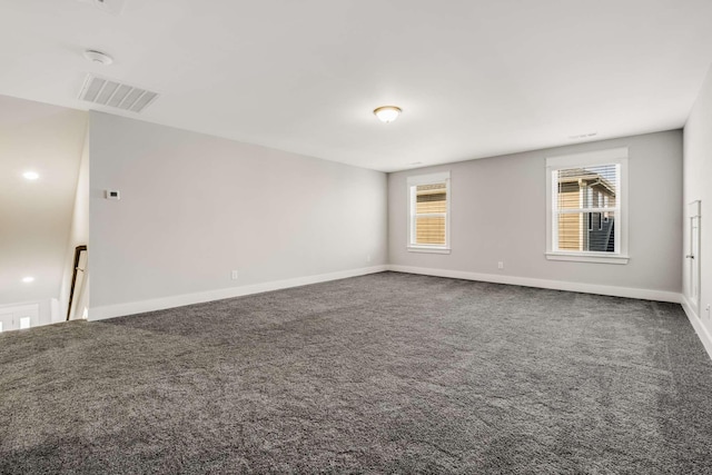 empty room featuring dark colored carpet