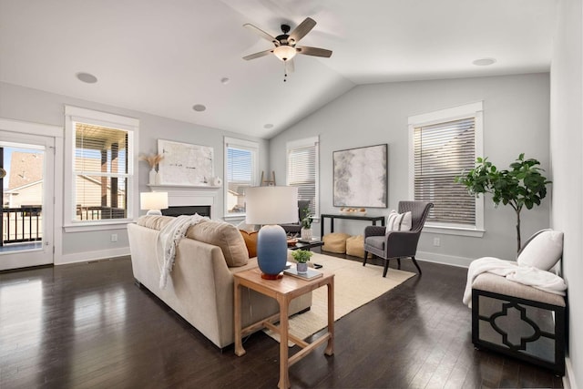 living room featuring ceiling fan, dark hardwood / wood-style floors, and lofted ceiling