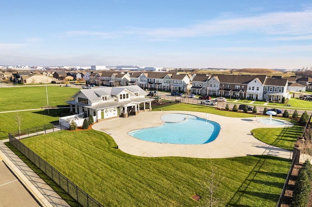 view of pool with a lawn and a patio