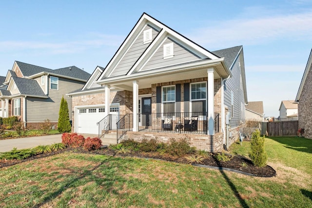 craftsman inspired home with a front yard, a porch, and a garage